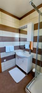 a bathroom with a sink and a mirror at Apartments Marijana in Rab