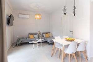 a living room with a table and a couch at Calmare suites in Rethymno Town