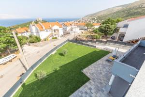 a view from the roof of a house with a lawn at Apartments Luka in Senj
