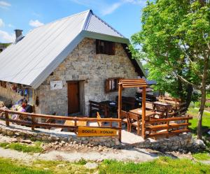 a small stone house with a metal roof at Bobića konak - Lukomir in Lukomir