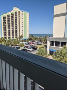 a balcony with a view of a parking lot and buildings at Beach Side Hotel in Myrtle Beach
