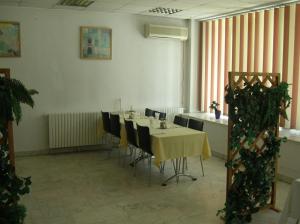 a dining room with a table and chairs at Federația Română de Scrimă - Hotel Floreta de Aur in Bucharest