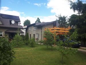 a house with a yard in front of it at Cienisty Zakątek in Augustów