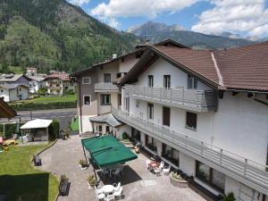 an aerial view of a building with mountains in the background at Liz Hotel & Apartments in Predazzo