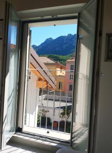 a window with a view of a building at sweet homes in Lecco