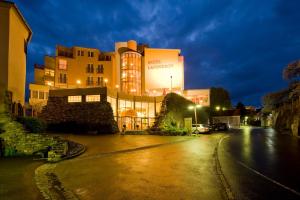a large building at night with a street at Hotel Landskron in Bruck an der Mur