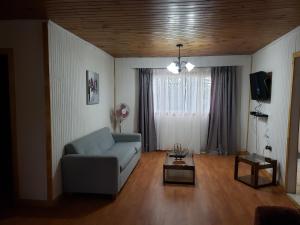 a living room with a couch and a table at Casa Aldunate, La calera in La Calera