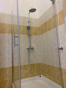 a shower with a glass door in a bathroom at Parentium town center in Poreč