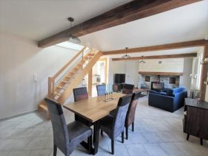 a dining room and living room with a table and chairs at The stopover in Bonneuil in Bonneuil-les-Eaux
