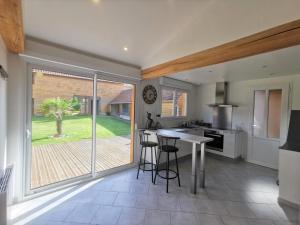 a kitchen with a large sliding glass door leading to a garden at The stopover in Bonneuil in Bonneuil-les-Eaux