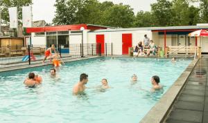 a group of people in a swimming pool at Jacuzzi & Sauna Villa 2 in Tzummarum