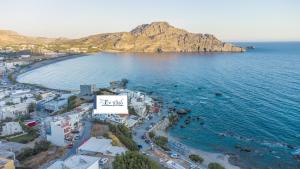 an aerial view of a beach with a sign that reads smile at En Plo Studios & Apartments in Plakias