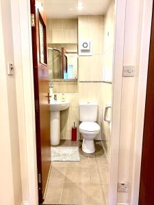 a bathroom with a toilet and a sink at Sea View in Ardrossan