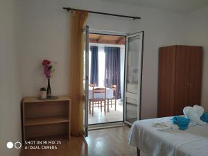 a bedroom with a sliding glass door leading to a dining room at Villa Franić in Saplunara
