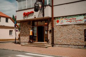 a brick building with an open door on a street at Browar Osjann - pokoje gościnne in Biała Podlaska