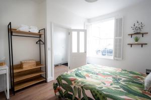 a bedroom with a bed and a window at The Teapot Cottage in town centre FREE parking in Stratford-upon-Avon