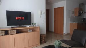 Televízia a/alebo spoločenská miestnosť v ubytovaní Yako Apartment - Wagrain Center