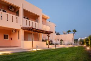 a building with a lawn in front of it at Cirillo Family Hotel-Christinas Studios in Mastihari