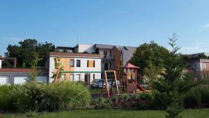 a house with a playground in a yard at Apartment in Balatonalmadi 36663 in Balatonalmádi