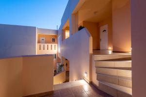 a view of a hallway with stairs in a house at Cirillo Family Hotel-Christinas Studios in Mastihari