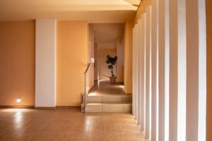 a hallway with stairs and a potted plant at Cirillo Family Hotel-Christinas Studios in Mastihari
