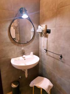 a bathroom with a sink and a mirror at Hotel Fidenza in Fidenza