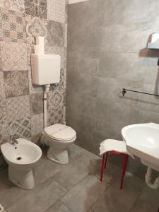 a bathroom with a toilet and a sink at Hotel Fidenza in Fidenza
