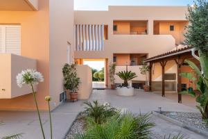 an external view of a house with a courtyard at Cirillo Family Hotel-Christinas Studios in Mastihari