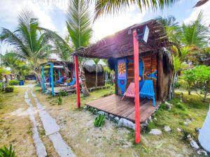 a small house with a playground with palm trees at Eco Cabañas Bluekay in Mahahual