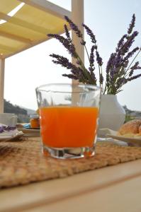 a glass of orange juice sitting on a table at B&B Fermata 106 da Carolina in Siculiana Marina