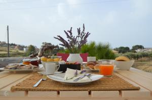 a table with breakfast foods and drinks on it at B&B Fermata 106 da Carolina in Siculiana Marina