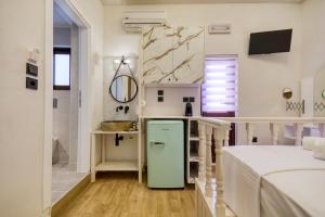 a small bathroom with a green refrigerator in a room at Bastion Luxury Medieval Accommodation in Rhodes Town