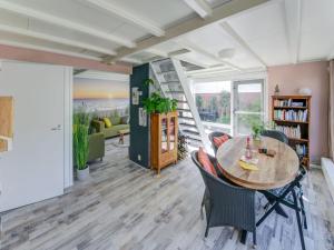 a living room with a table and chairs and a ladder at Comfortable vacation home near the sea in Noordwijkerhout