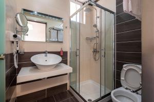 a bathroom with a toilet and a sink and a shower at Cirillo Family Hotel-Christinas Studios in Mastihari