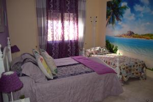 a bedroom with two beds and a painting of the ocean at Villa la Masia in Miami Platja +36 photos