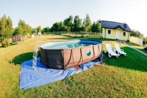 a hot tub in the middle of a yard at Brzozowy Zakątek in Dąbki