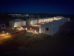 an overhead view of a group of white buildings at night at Sahara Luxury Desert Camp in Merzouga