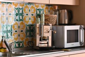 a coffee maker sitting on a counter next to a microwave at La Memolina B&B in Salerno