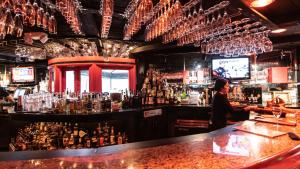 a bar with a man standing at a bar at Americas Best Value Inn Rancho Palos Verdes in Rancho Palos Verdes