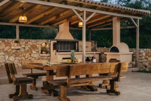 a wooden table and benches on a patio at Villa Elithea in Éxo Khóra