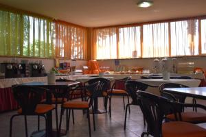 a dining room with tables and chairs and windows at Orzihotel in Orzivecchi +29 photos