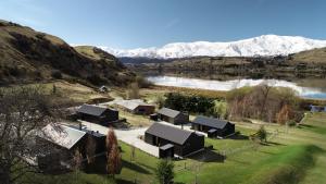 an aerial view of a farm with mountains in the background at The Cottages at Lake Hayes in Queenstown