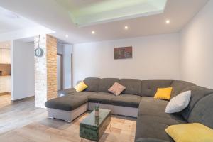a living room with a couch and a table at Villa Strikina kuca in Slivno