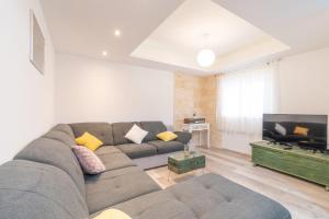 a living room with a couch and a television at Villa Strikina kuca in Slivno