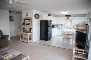 a kitchen and living room with a black refrigerator at 57218 Island Club Lane Home in Hatteras