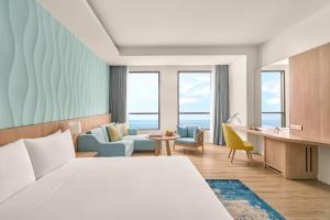 a hotel room with a bed and a desk at Holiday Inn Resort Ho Tram Beach by IHG in Ho Tram