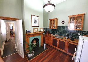 a kitchen with a fireplace in the middle of it at Burra Railway Station BnB in Burra