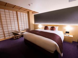 a bedroom with a large bed and a large window at Nagi Kyoto Shijo in Kyoto