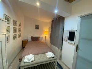 a small bedroom with a bed and a window at Lyric Studio in Sibiu