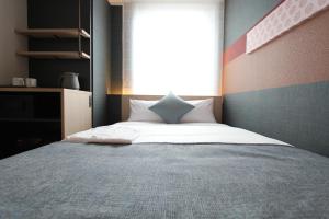 Postel nebo postele na pokoji v ubytování KOKO HOTEL Tsukiji Ginza